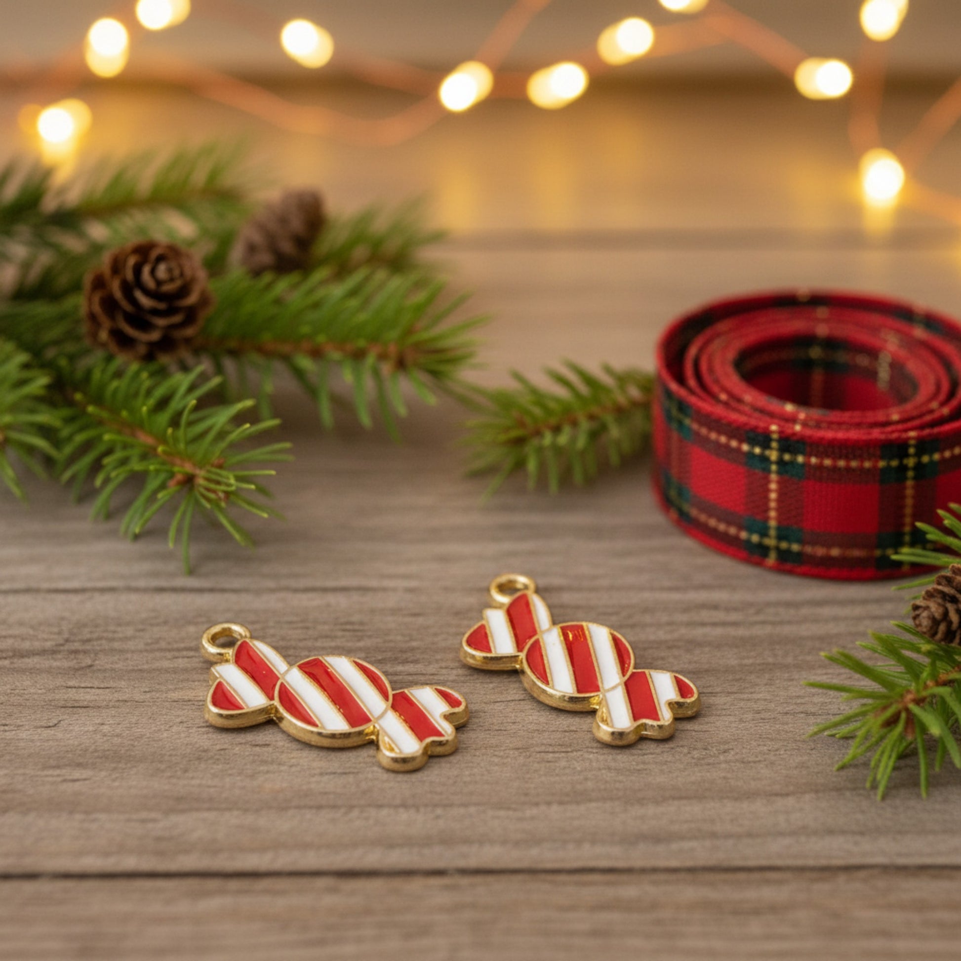 Hackberry Creek peppermint candy charms with red and white enamel and gold-plated backing for Christmas crafts.