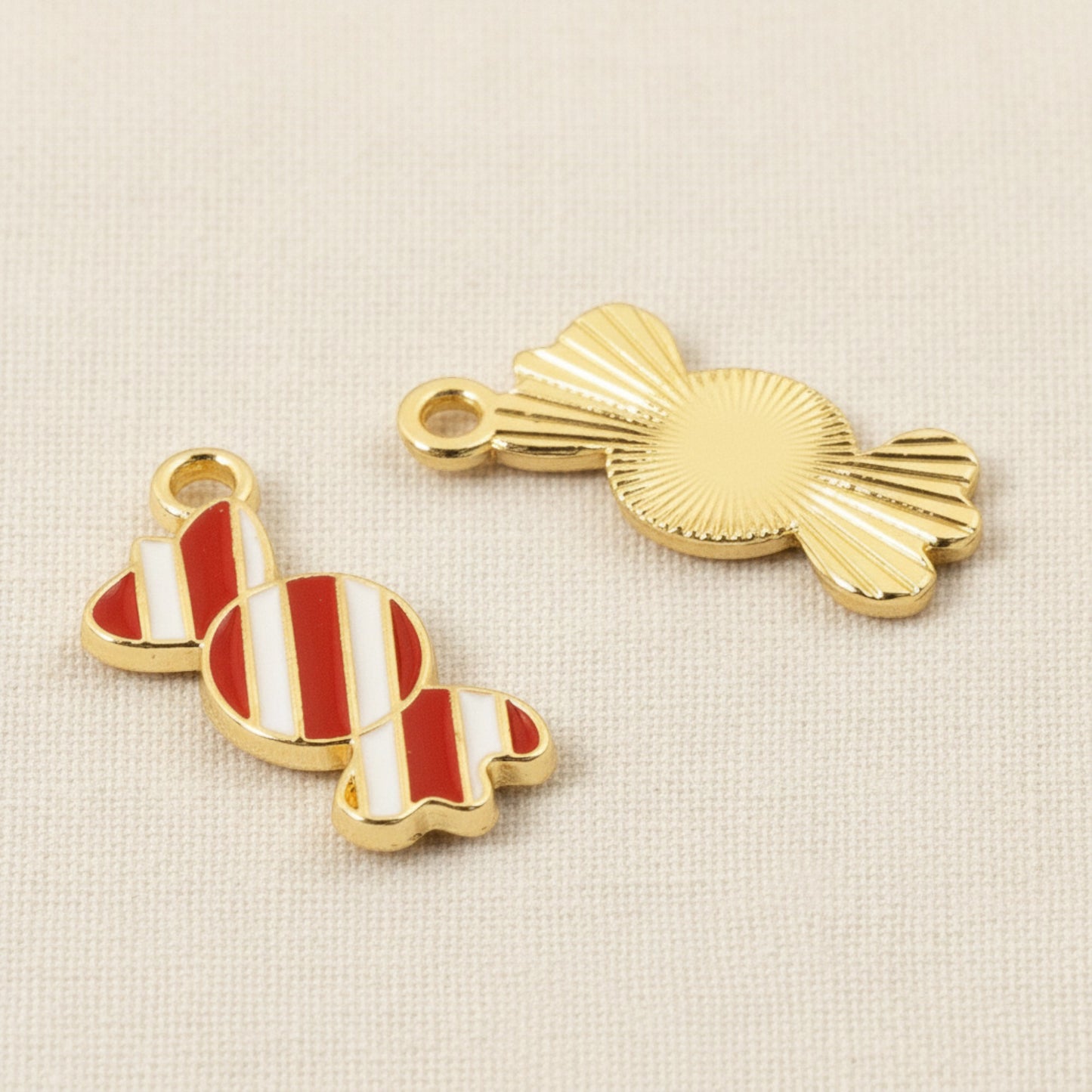 Hackberry Creek peppermint candy charms with red and white enamel and gold-plated backing for holiday jewelry crafts.