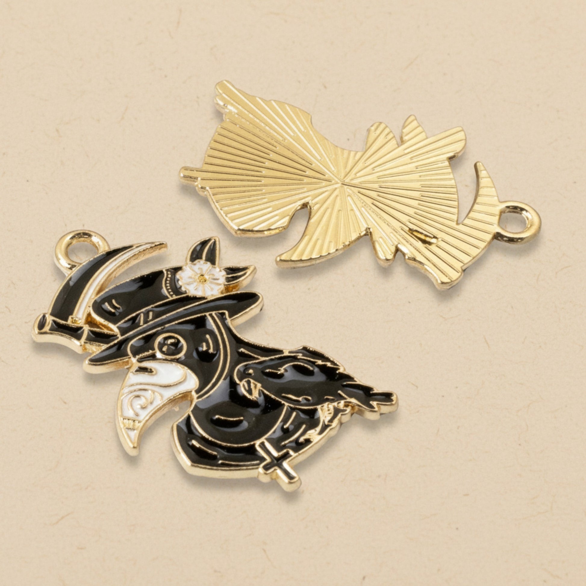 Hackberry Creek plague doctor raven head charms in black and white enamel with gold plating for gothic jewelry