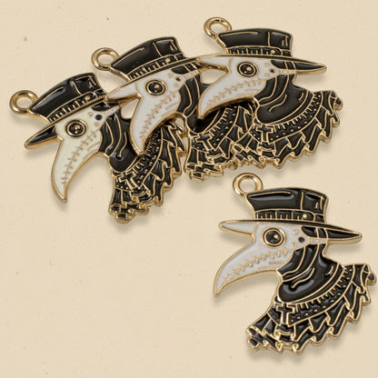 Hackberry Creek set of four gold-plated metal alloy plague doctor raven pendants with black and white enamel details.