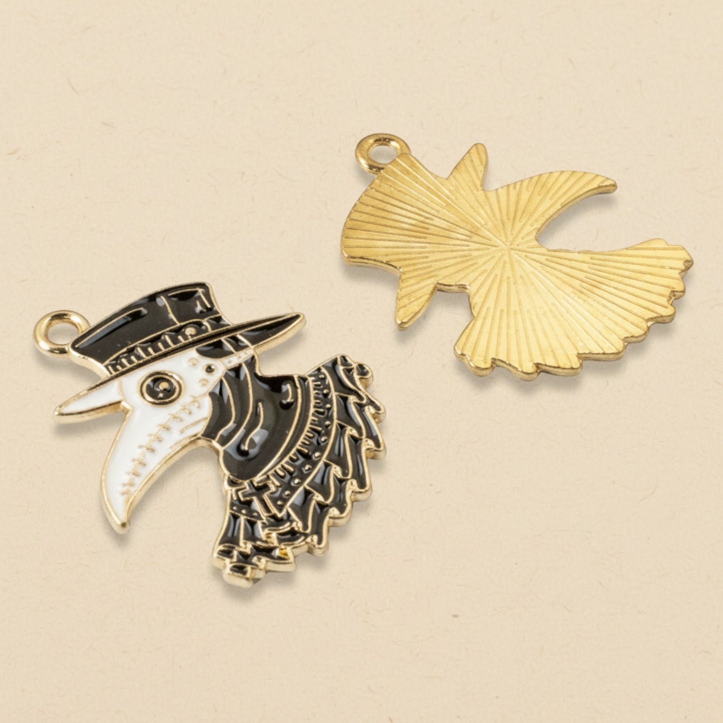 Hackberry Creek plague doctor raven head pendants in black and white enamel with gold plating for gothic jewelry