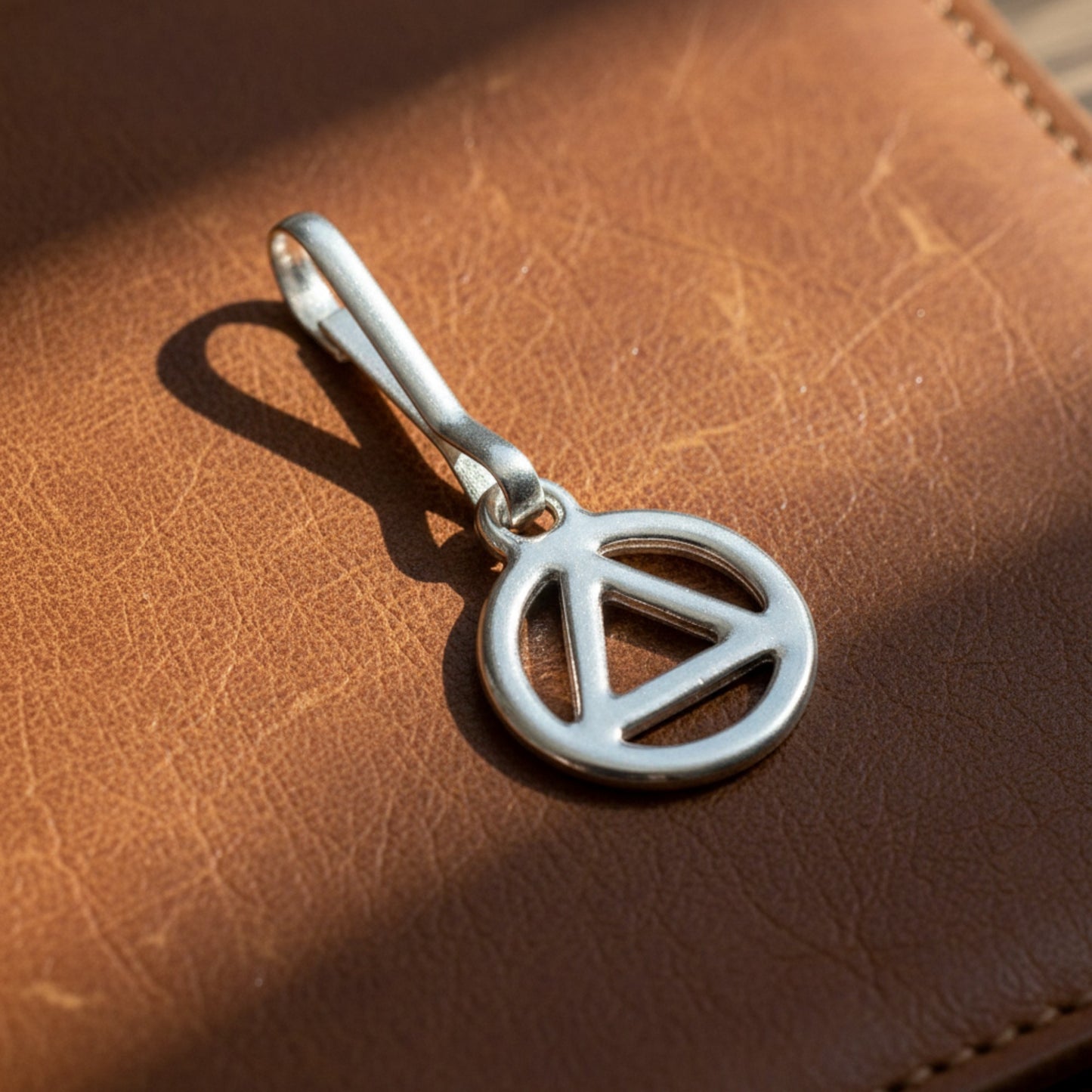 Hackberry Creek silver triangle recovery charm with stainless steel clip. Symbol of sobriety and healing.