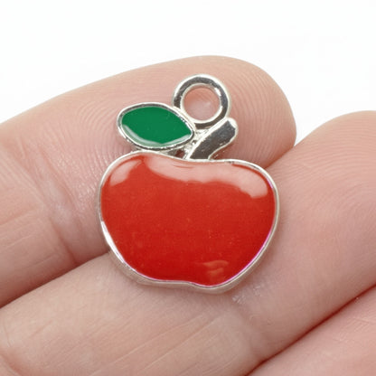 Hackberry Creek bright red enamel apple charm with green leaf and silver loop for jewelry making.