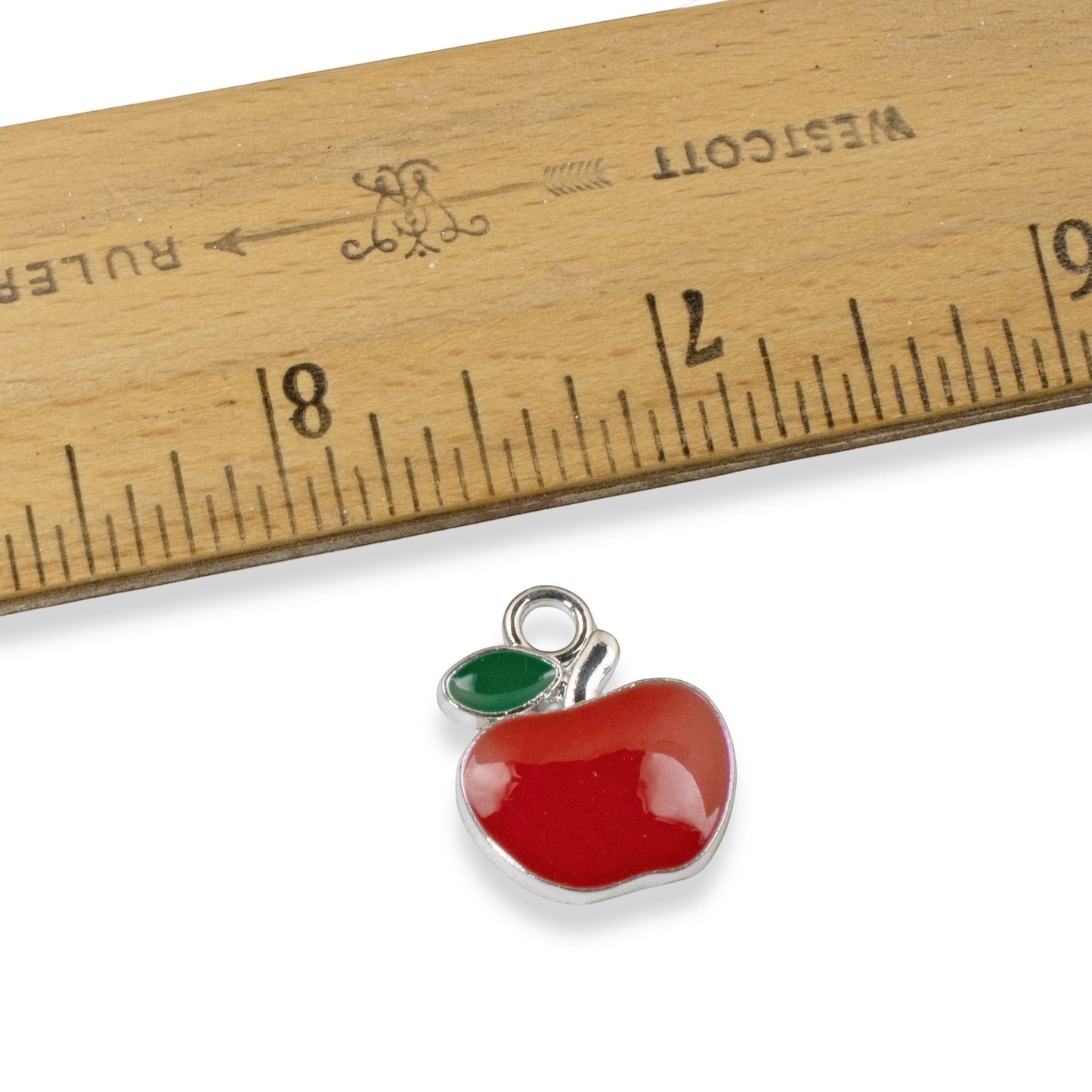 Hackberry Creek bright red enamel apple charm with green leaf detail, silver alloy, for jewelry making.