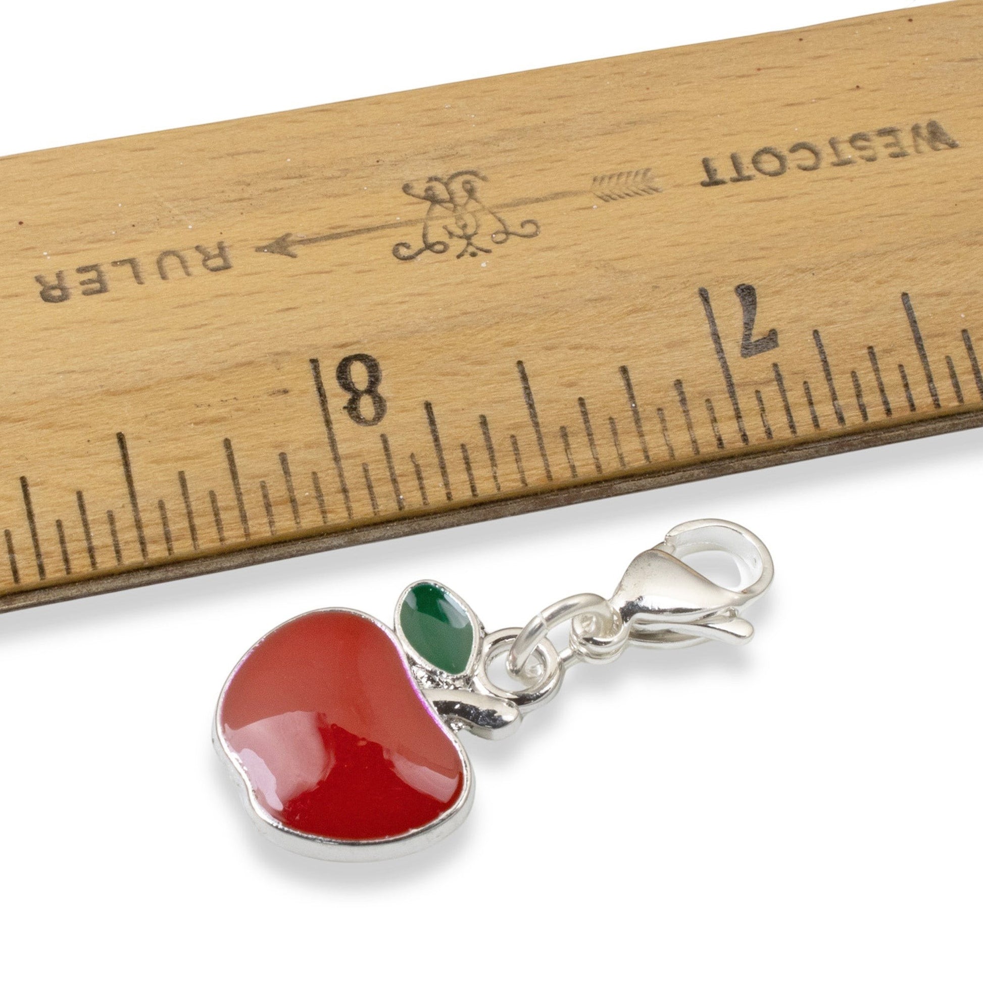 Hackberry Creek red apple charm with green leaf accent, silver-plated brass with enamel, 1 1/2" long.