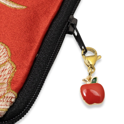 Hackberry Creek red apple enamel charm with gold-plated clasp attached to a red fabric zipper pull