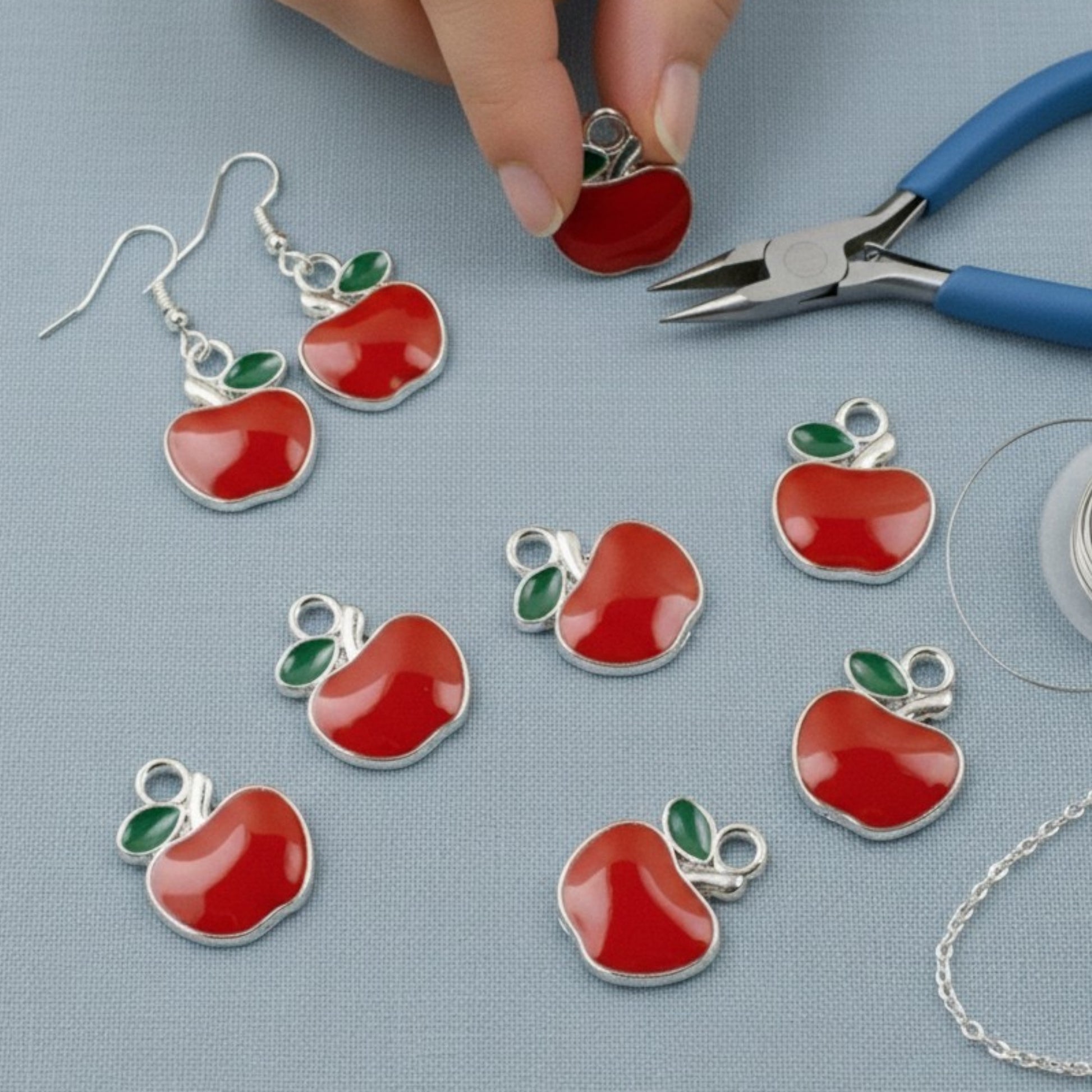 Hackberry Creek bright red enamel apple charms with green leaves, silver metal alloy, for jewelry making.