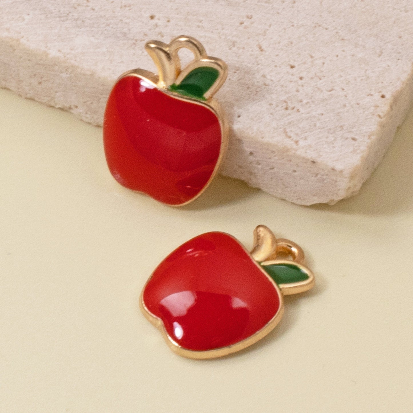 Hackberry Creek glossy red enamel apple charms with gold plating and green leaf detail for jewelry making