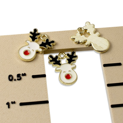 Hackberry Creek reindeer enamel charms with white faces, red noses, and black antlers on gold-plated metal bases.