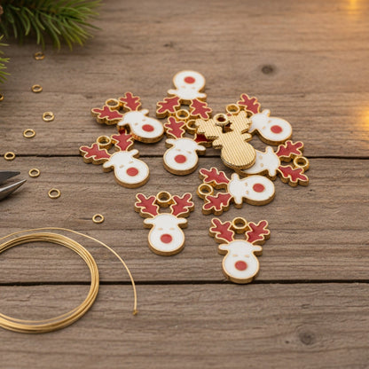 Hackberry Creek reindeer charms with white enamel faces, red noses, and red antlers on gold-plated metal for crafts.
