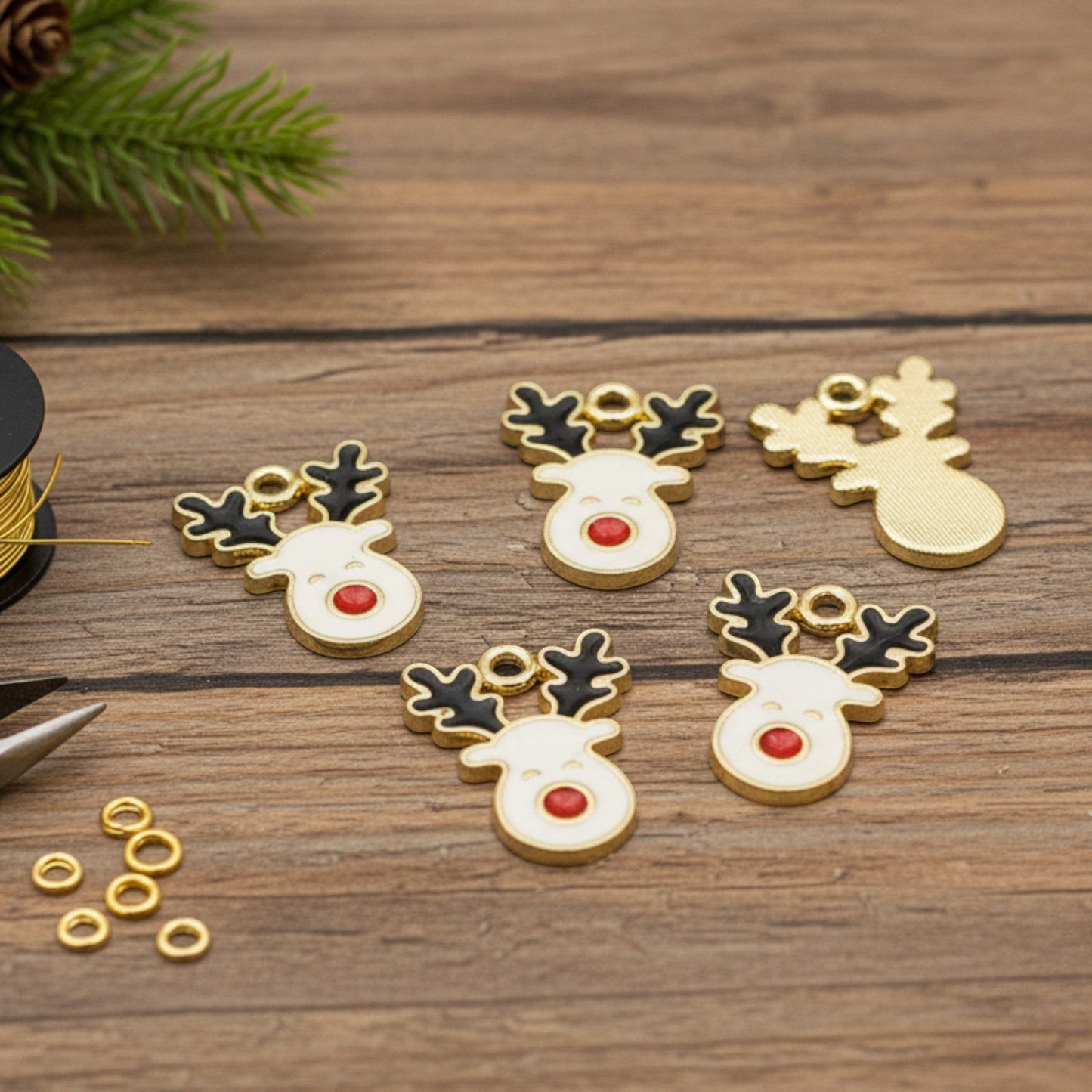 Hackberry Creek reindeer enamel charms with gold-plated metal, white faces, red noses, and black antlers for jewelry.