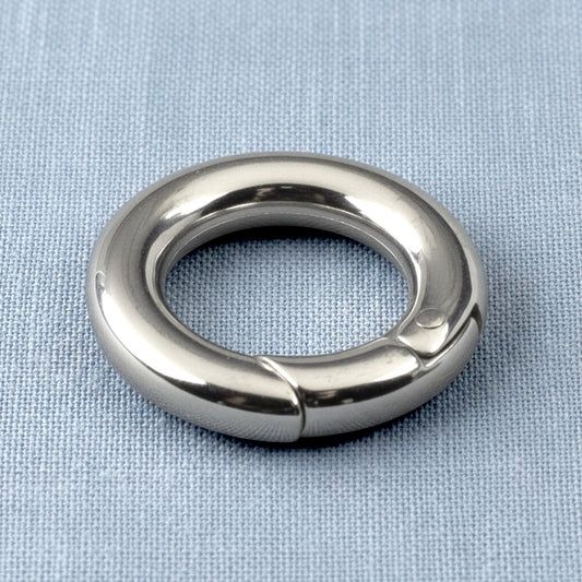 Hackberry Creek 15mm round stainless steel carabiner spring clasp with a polished silver finish on a blue fabric base.