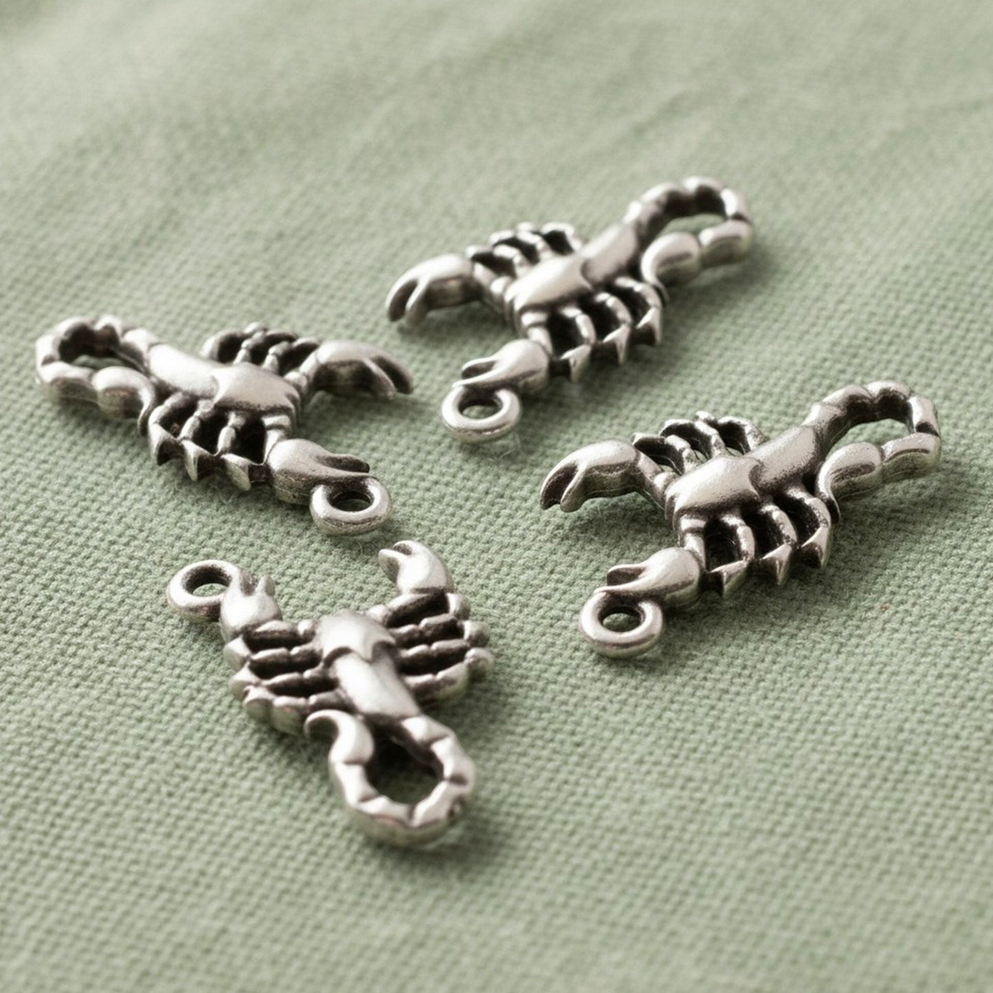 Hackberry Creek 4-pack antique silver plated scorpion charms with detailed relief design.