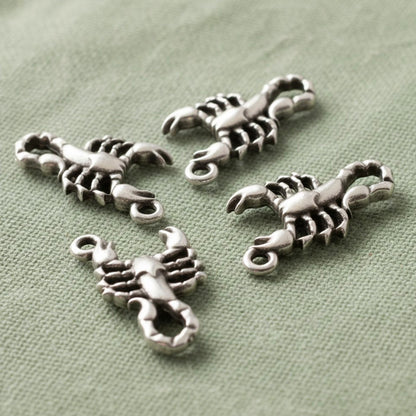 Hackberry Creek 4-pack antique silver plated scorpion charms with detailed relief design.