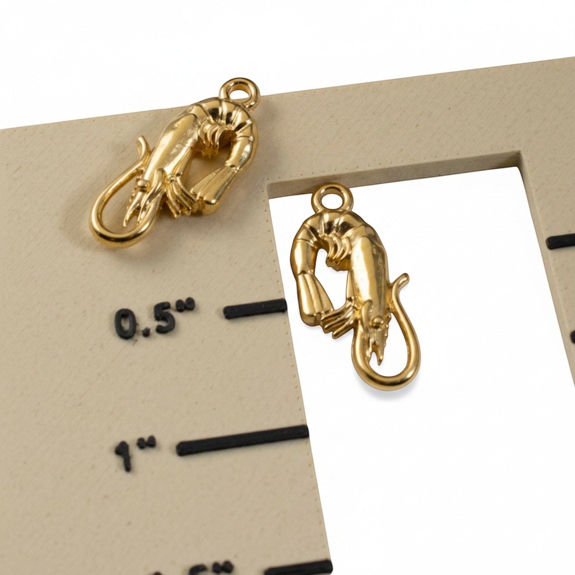 Hackberry Creek 24K gold plated shrimp charms, 2-pack. Detailed, bright gold finish, perfect for coastal jewelry.