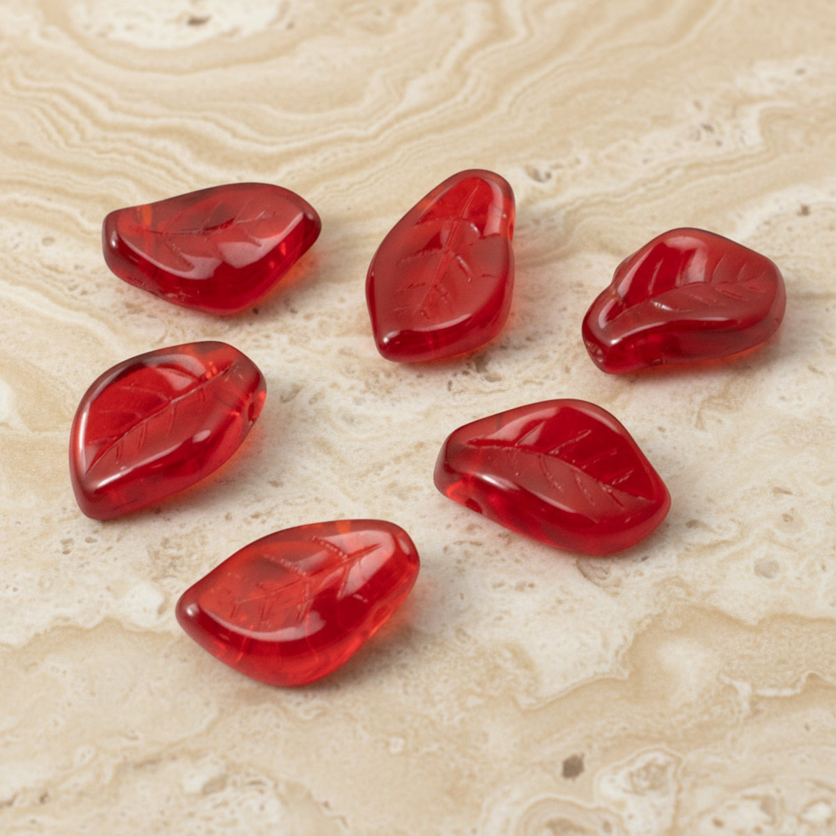 Hackberry Creek transparent Siam red Czech glass leaf beads with intricate veining for jewelry making