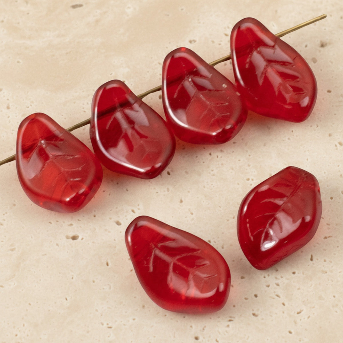 Hackberry Creek transparent Siam red Czech glass leaf beads with intricate veining for jewelry making
