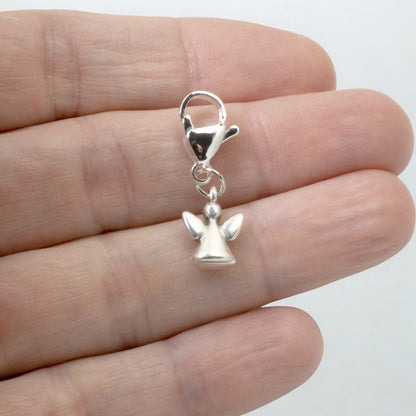 Hackberry Creek silver guardian angel charm with a lobster clasp held in a hand for scale