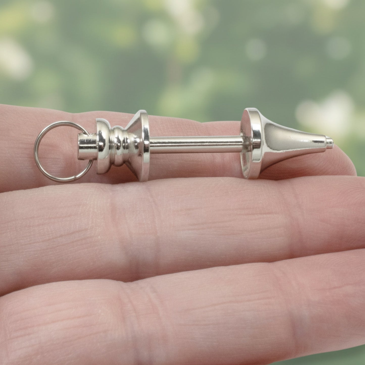 Hackberry Creek silver zinc alloy beadable pendant held in hand for jewelry making and custom keychain designs