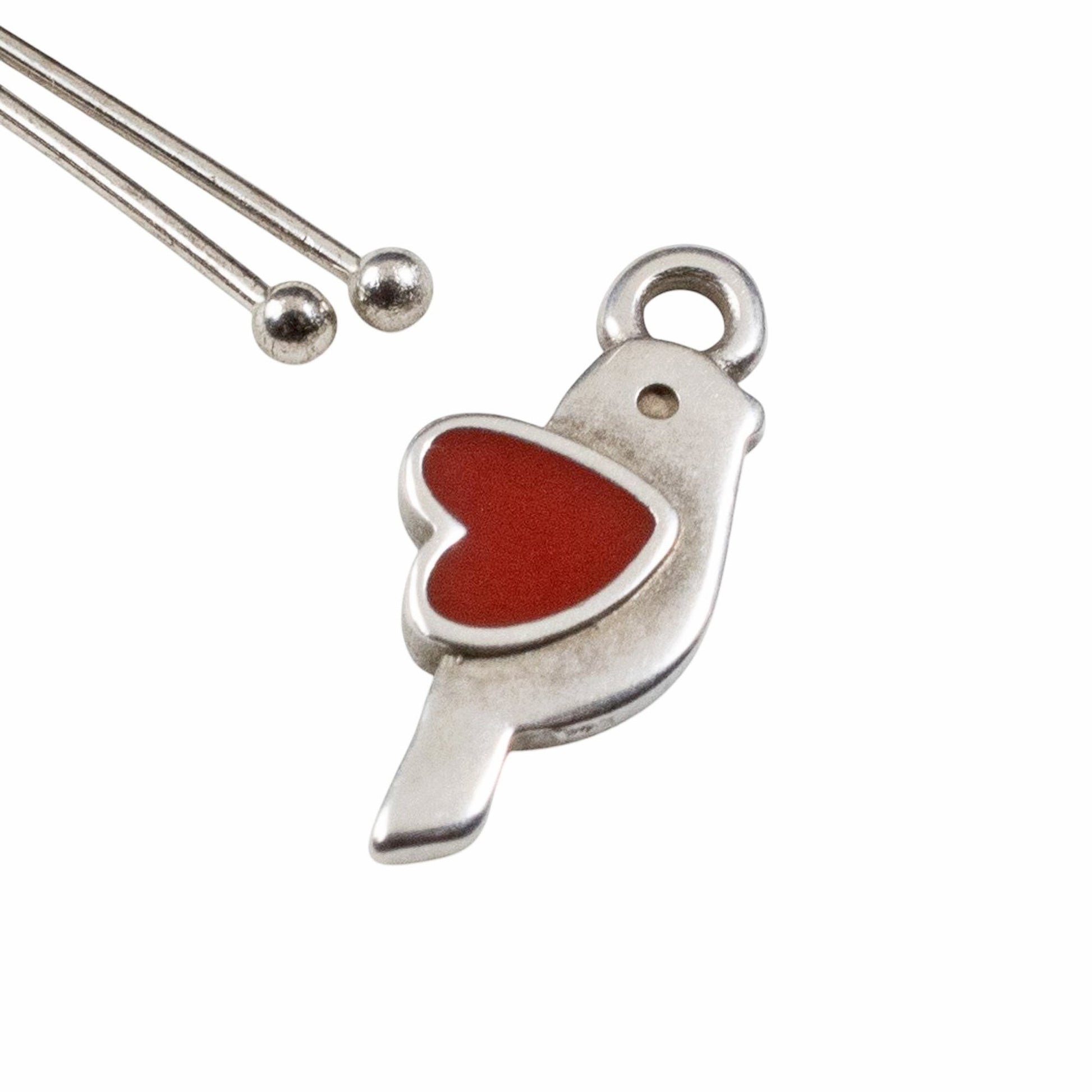 Hackberry Creek antique silver bird charm with red enamel heart, 8x18mm, for jewelry making.