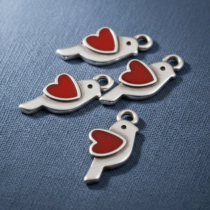 Hackberry Creek antique silver bird charms with red enamel hearts, 8x18mm. Pack of 4.