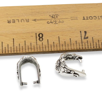 Hackberry Creek TierraCast antique silver pinch bails with floral vine design next to a ruler for scale
