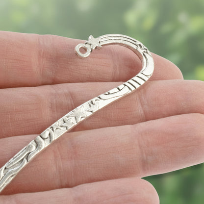 Hackberry Creek antique silver zinc alloy hook bookmark with celestial star and sun engravings held in a hand