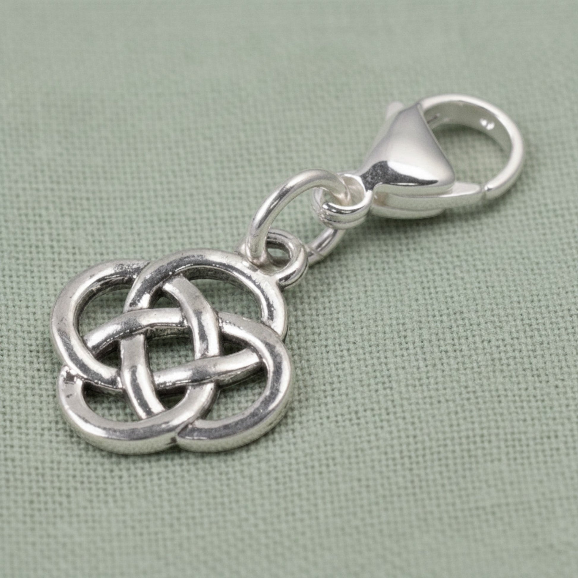 Hackberry Creek silver plated metal alloy Celtic knot charm with stainless steel lobster clasp. Open design.