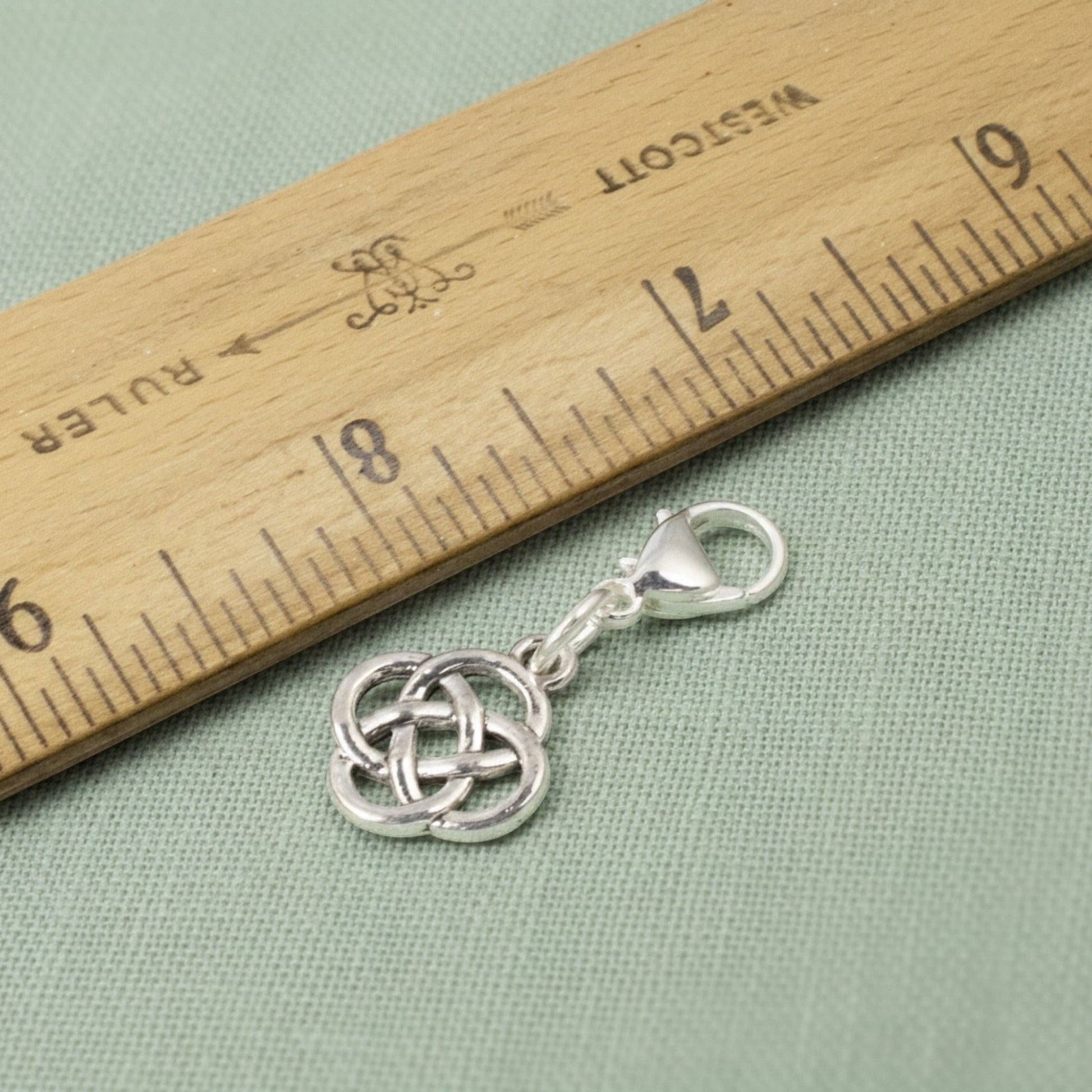 Hackberry Creek silver plated metal alloy Celtic knot charm with stainless steel lobster clasp, 1 3/8" length.