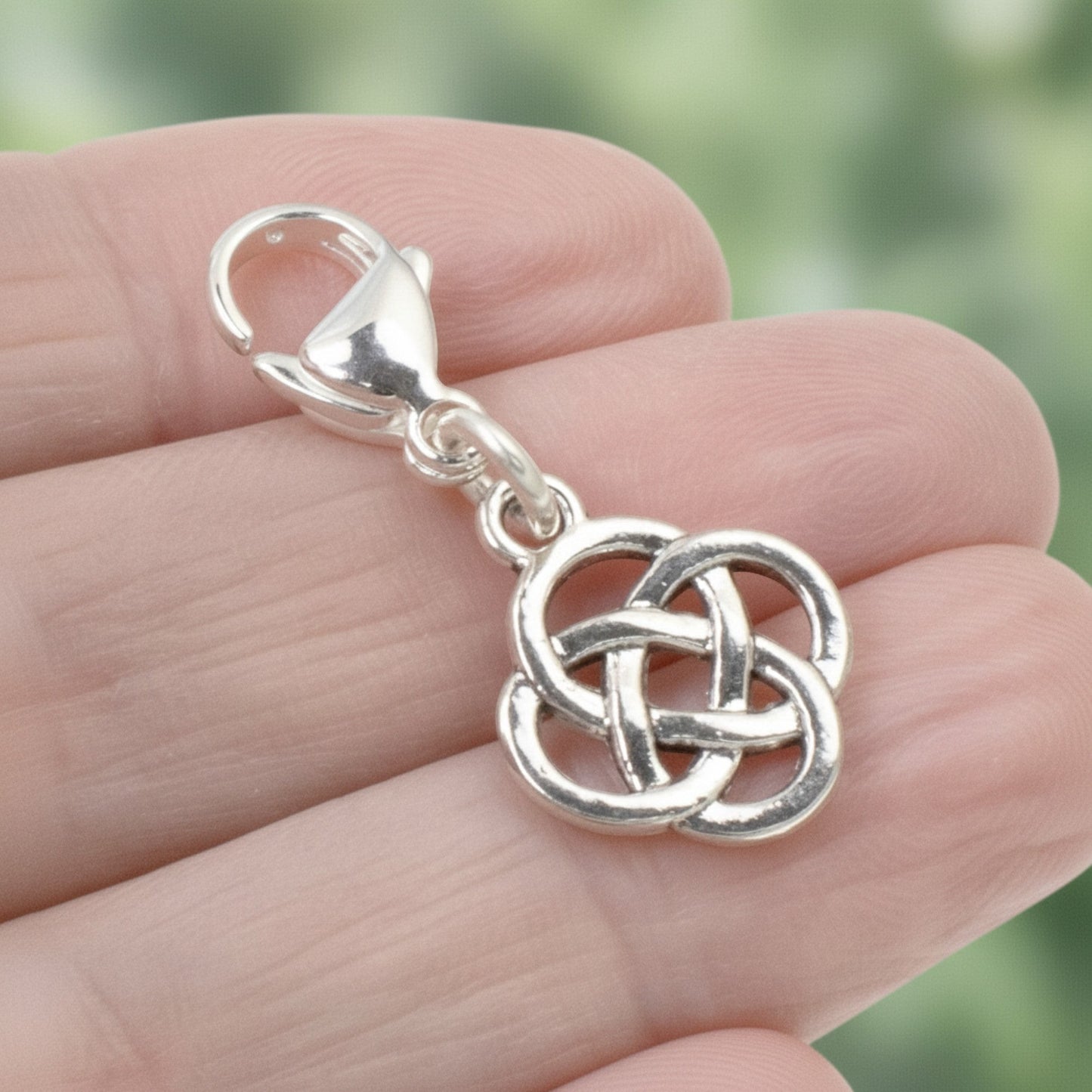 Hackberry Creek silver plated metal alloy Celtic knot charm with stainless steel lobster clasp. Open design.
