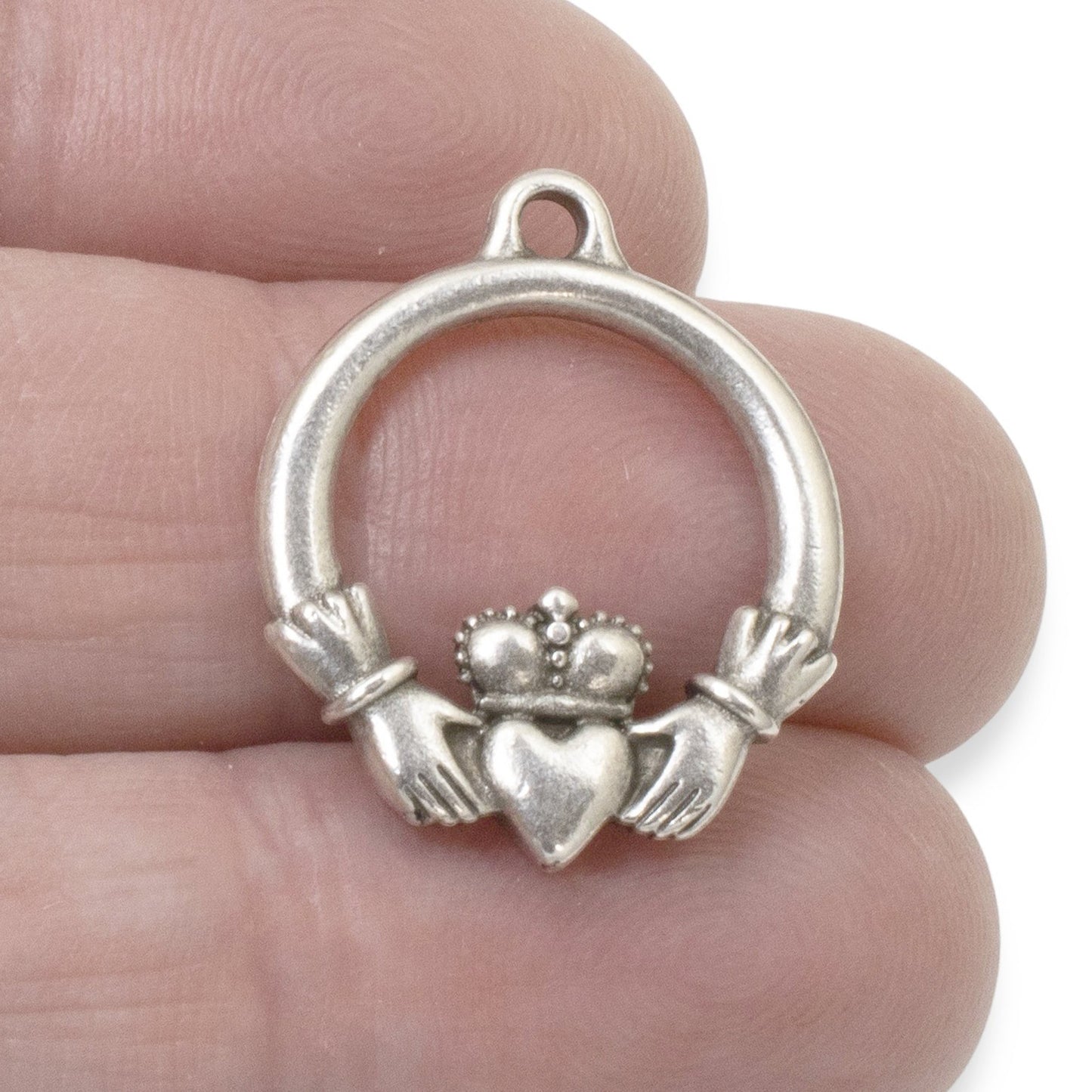 Hackberry Creek antique silver Claddagh pendant charm, crafted from pewter with .999 fine silver plating. Features hands holding a heart topped with a crown.