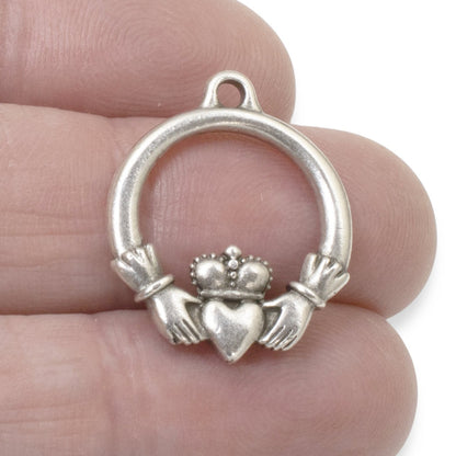 Hackberry Creek antique silver Claddagh pendant charm, crafted from pewter with .999 fine silver plating. Features hands holding a heart topped with a crown.