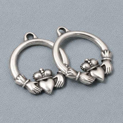 Hackberry Creek antique silver Claddagh charms, 2-pack pewter pendants with .999 fine silver plating, symbolizing love and friendship.