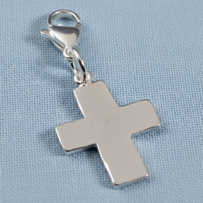 Hackberry Creek silver cross charm with a lobster clasp, featuring a distressed finish for bags or jewelry.
