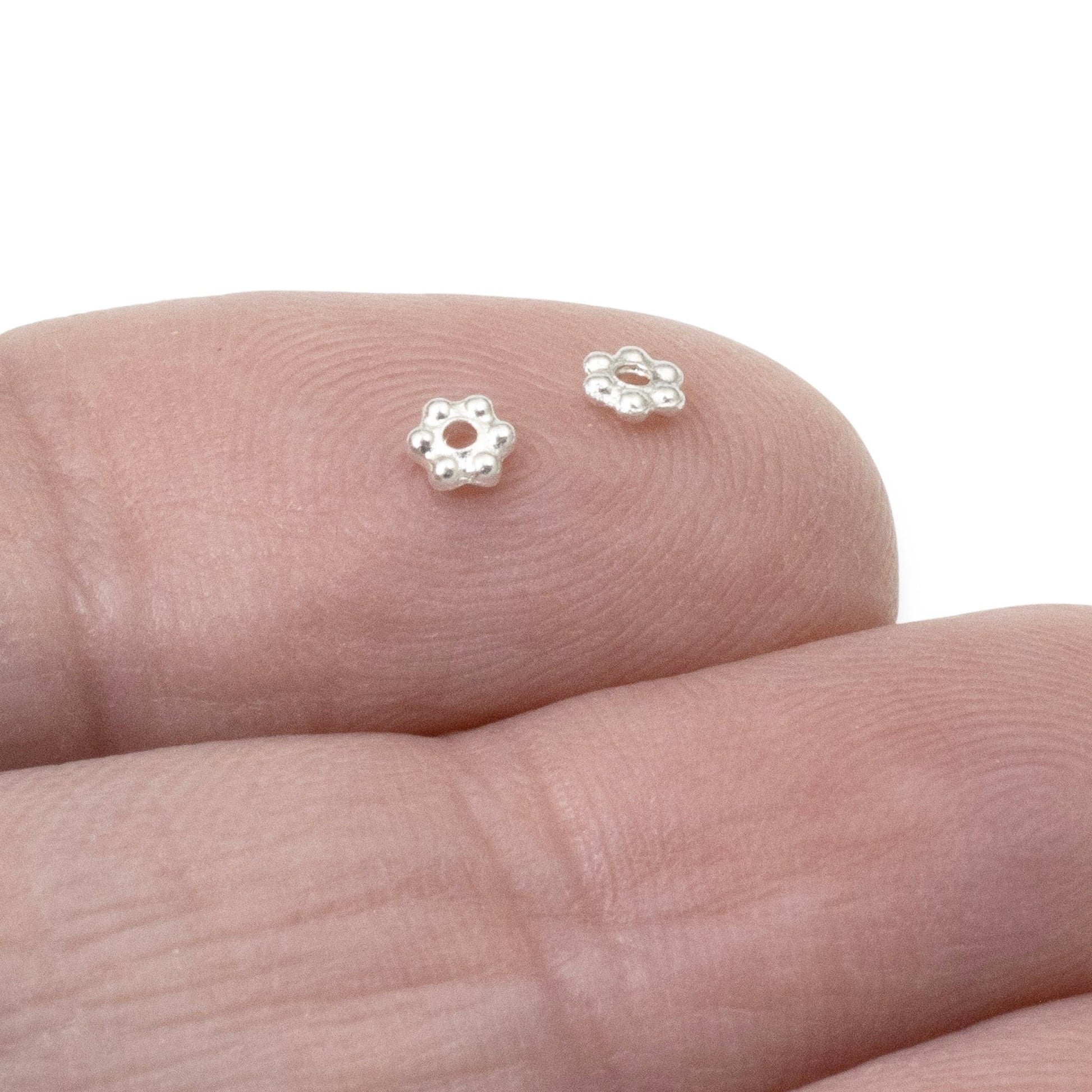 Hackberry Creek 50 bright silver 3mm daisy spacer beads made of lead-free pewter with fine silver plating.