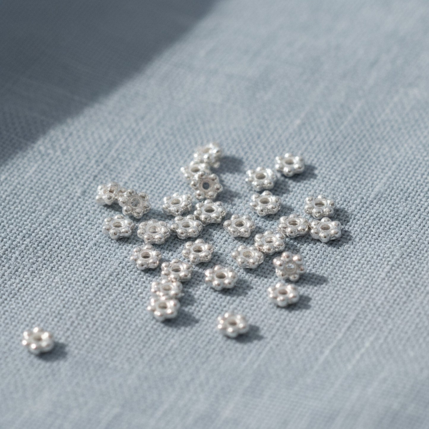 Hackberry Creek 50 bright silver 3mm daisy spacer beads, designed by TierraCast, made from lead-free pewter with fine silver plating.