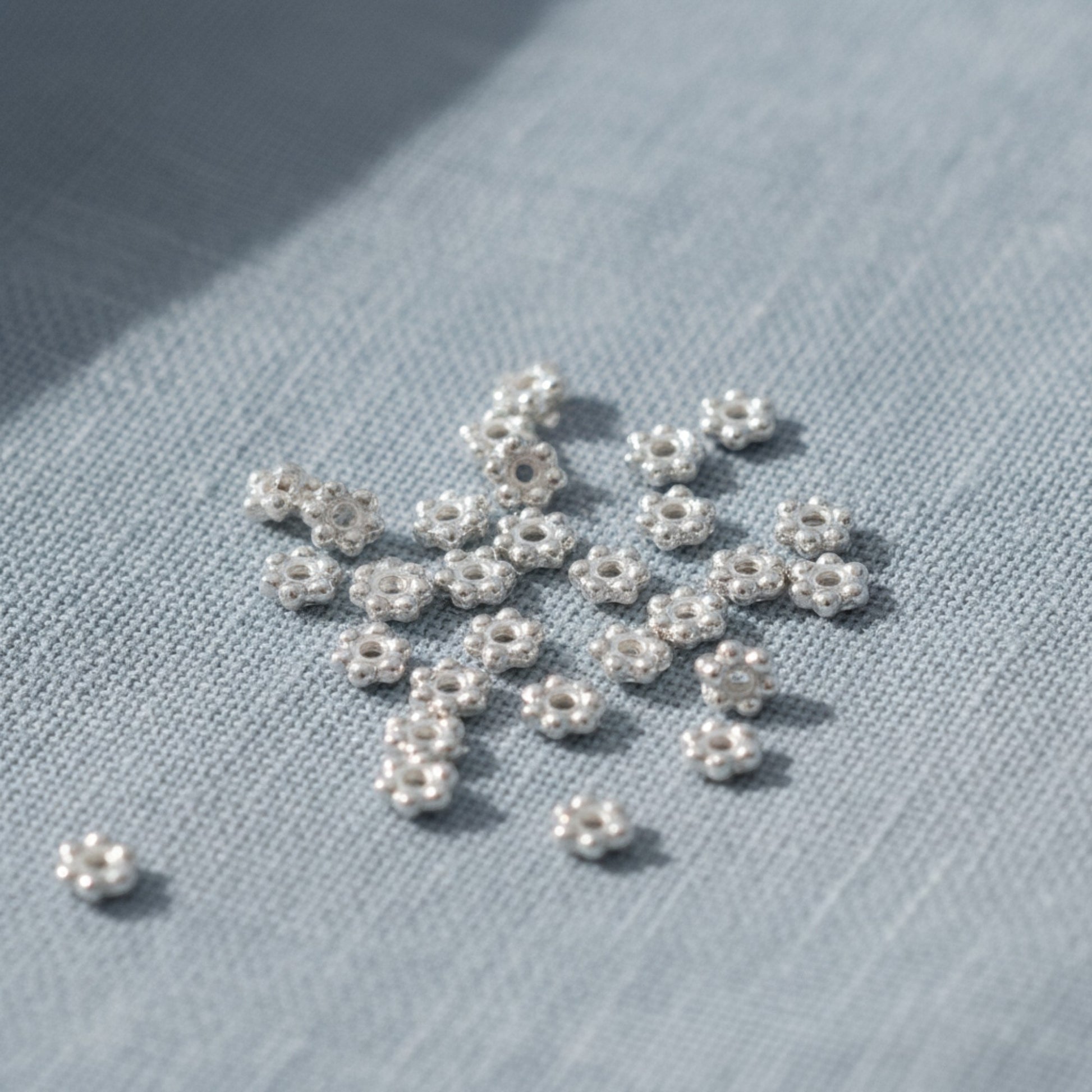 Hackberry Creek 50 bright silver 3mm daisy spacer beads, designed by TierraCast, made from lead-free pewter with fine silver plating.
