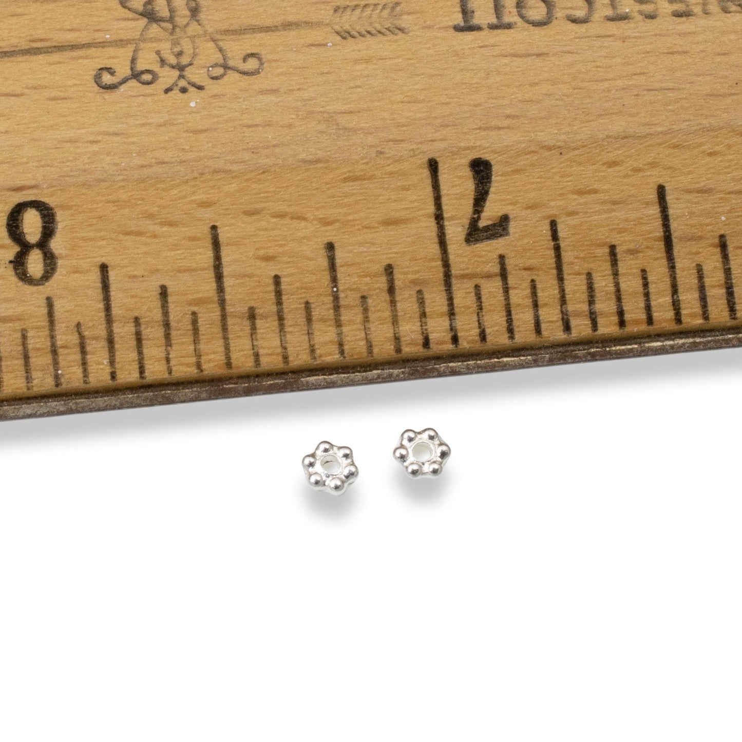 Hackberry Creek 50 bright silver 3mm daisy spacer beads made of lead-free pewter with fine silver plating.