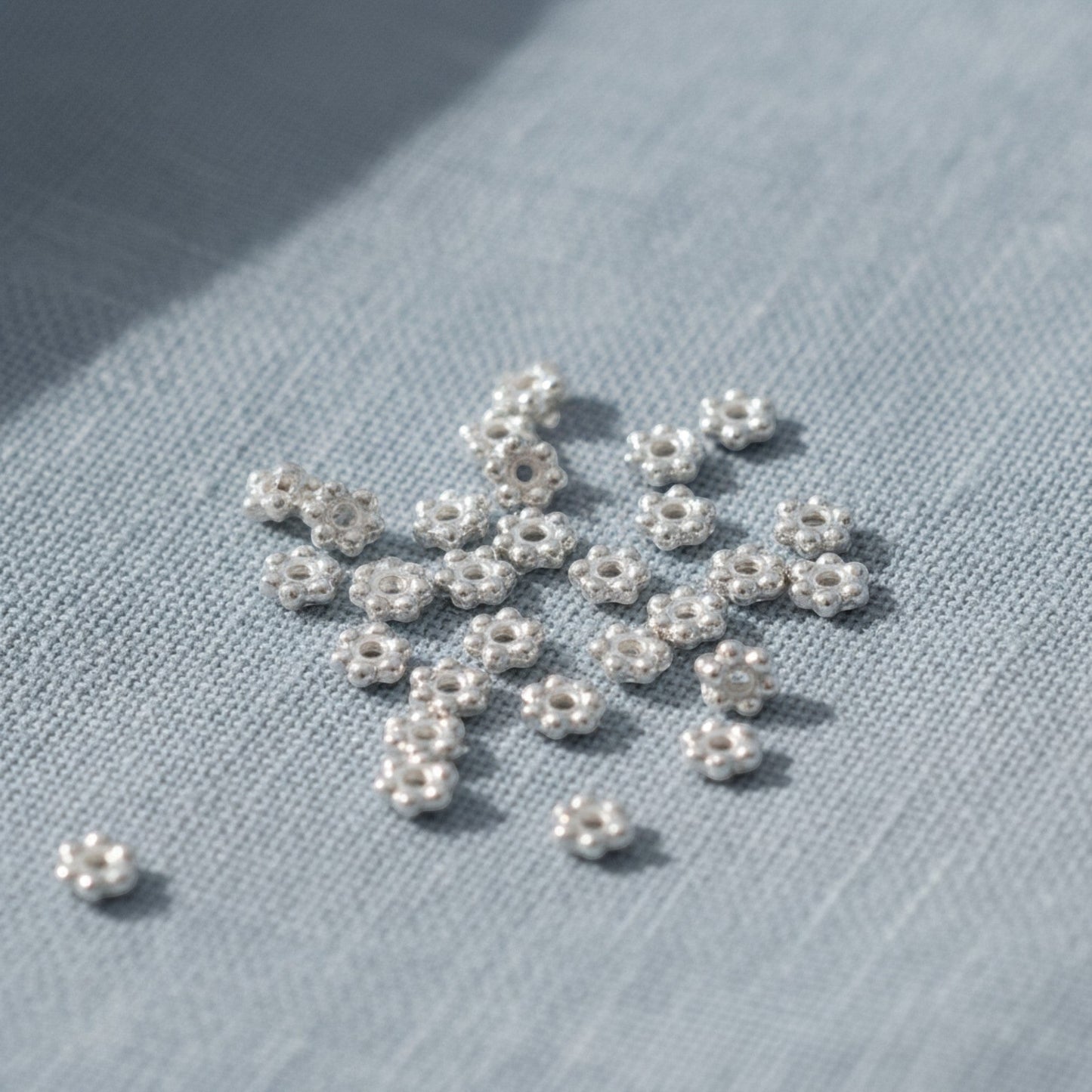 Hackberry Creek 500 bright silver 3mm daisy heishi spacer beads made of pewter with silver plating.