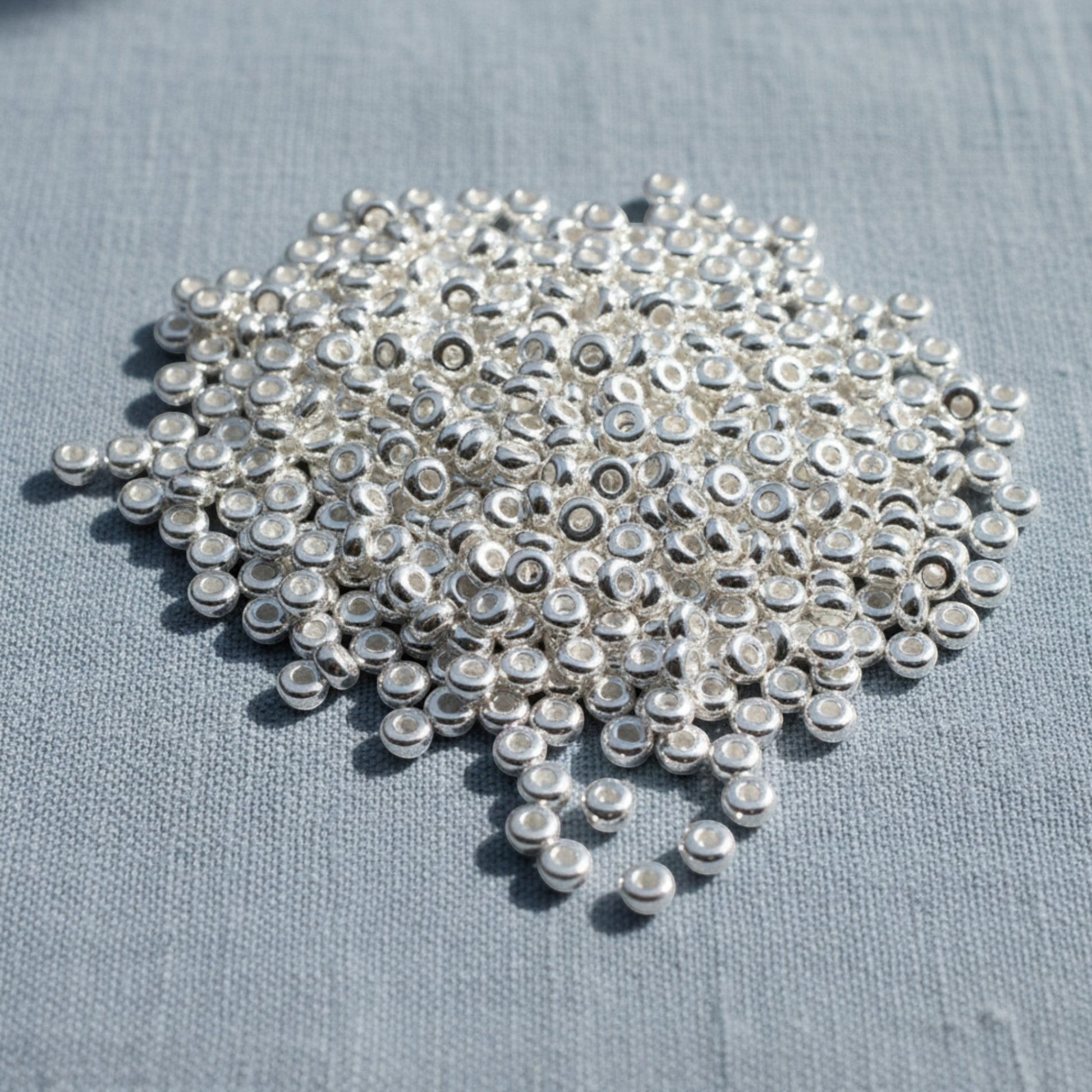 Hackberry Creek shiny silver 3mm disk beads, smooth heishi spacers, 500 pack, made of pewter with .999 fine silver plating.