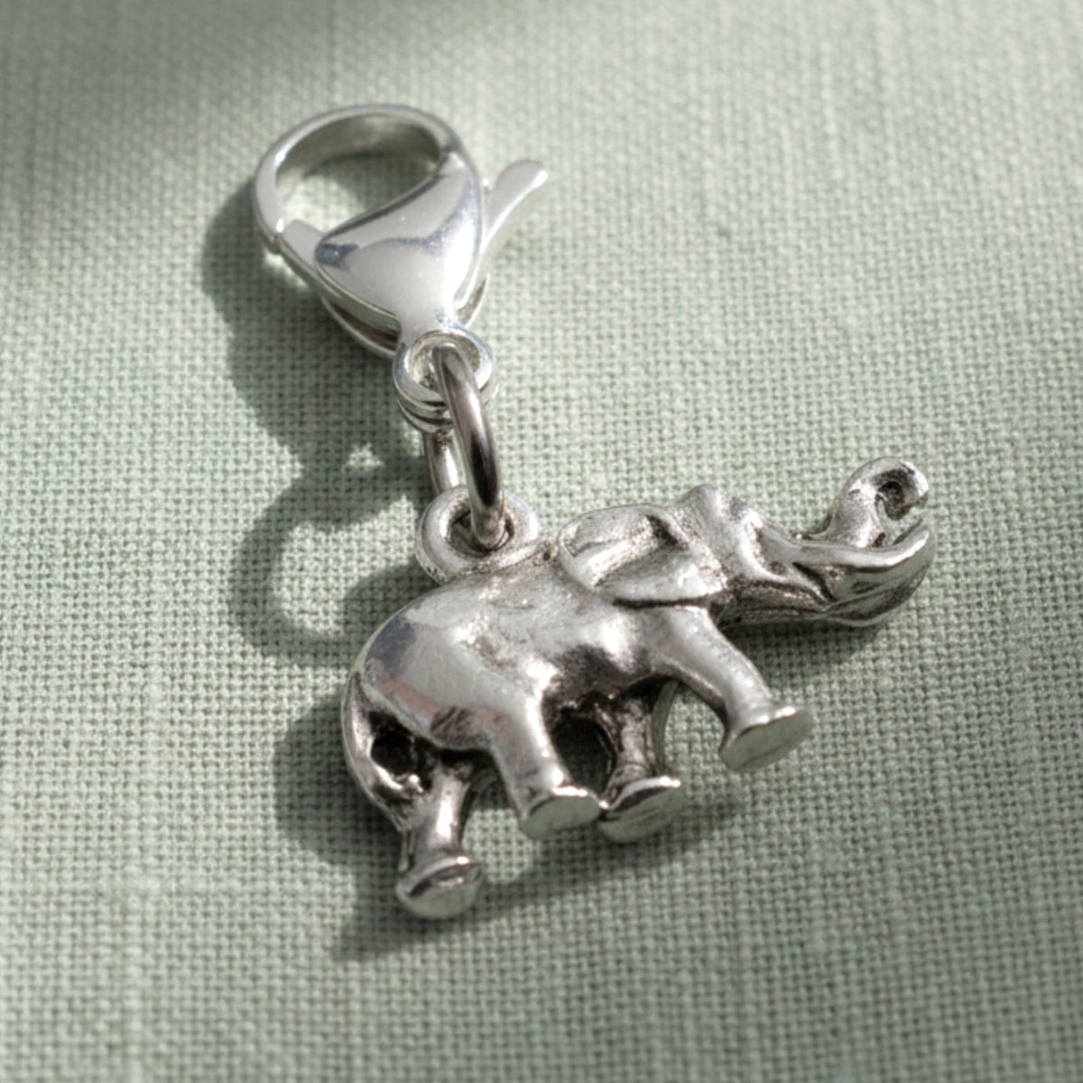 Hackberry Creek silver plated pewter elephant charm with a lobster clasp and detailed trunk up design