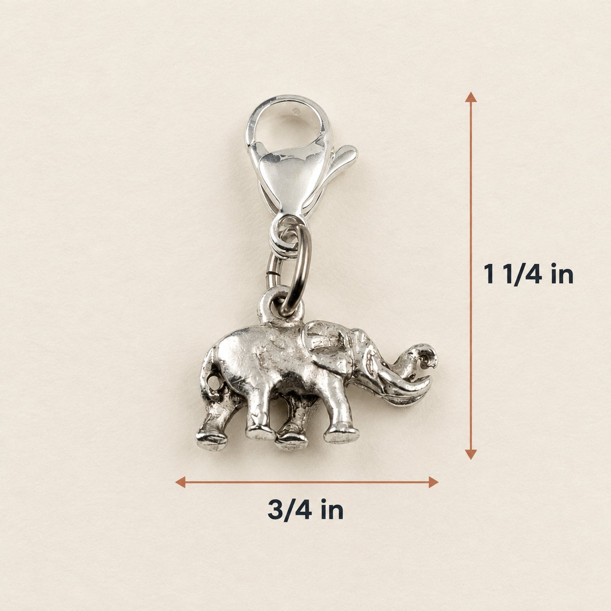 Hackberry Creek silver plated pewter elephant charm with a lobster clasp and raised trunk design on a neutral background