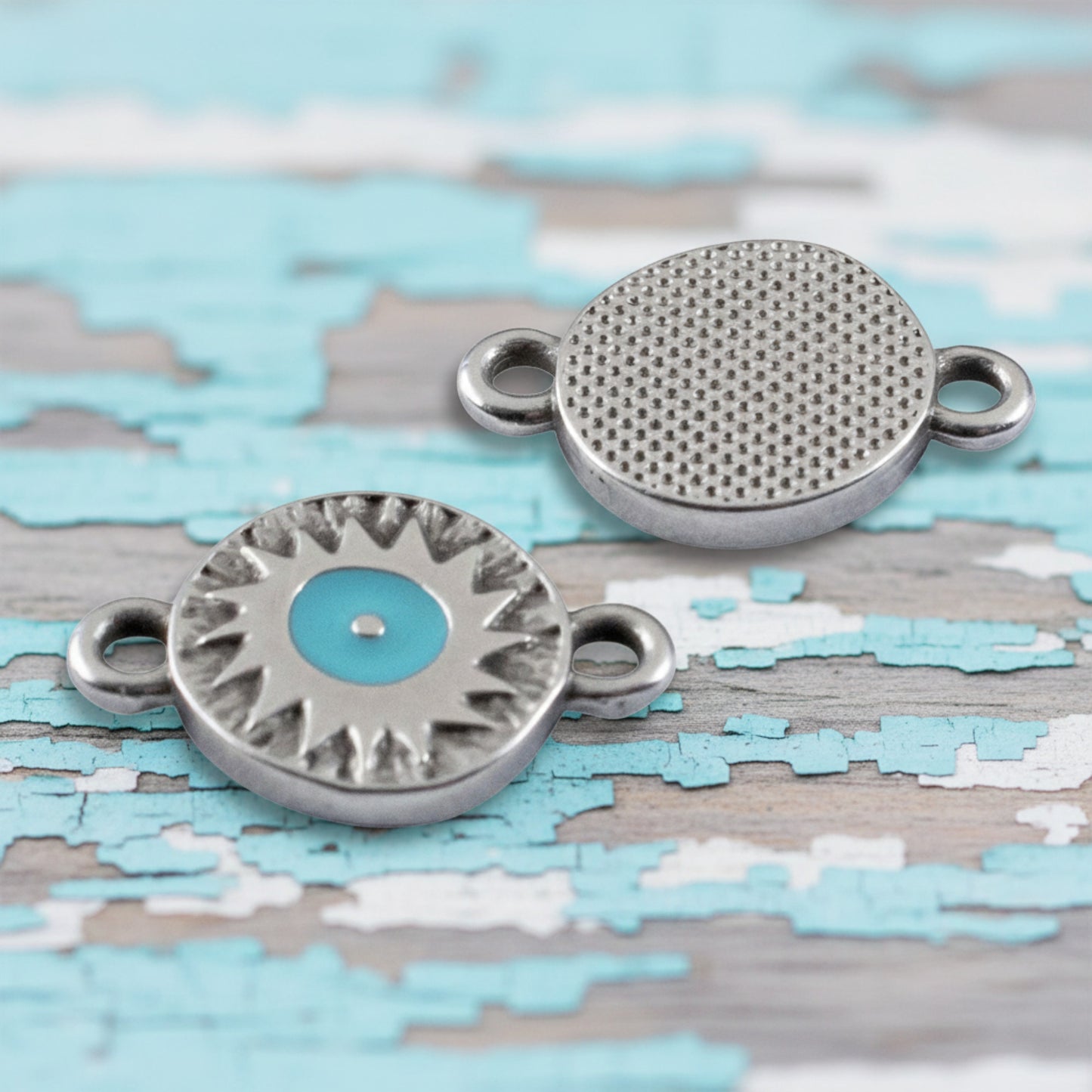 Hackberry Creek antique silver evil eye connector charms with aqua enamel centers and textured starburst details