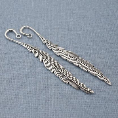 Hackberry Creek silver feather bookmark bases with etched detail and charm loops for DIY craft projects.