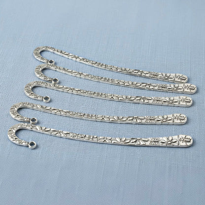 Hackberry Creek silver zinc alloy hook bookmarks with raised floral and butterfly patterns in a 5-pack set.