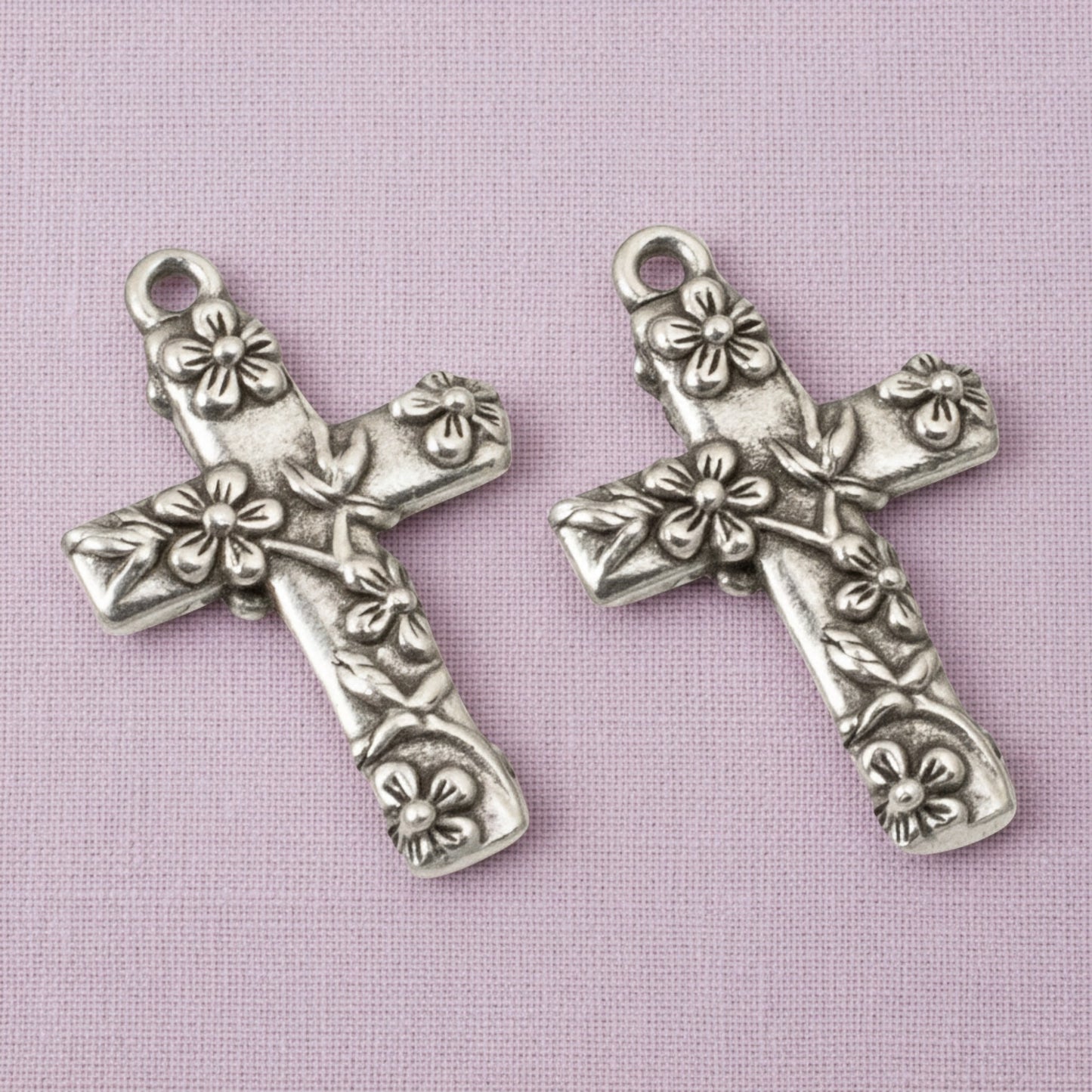 Hackberry Creek silver-plated pewter floral cross pendants with intricate raised flower details for religious jewelry.