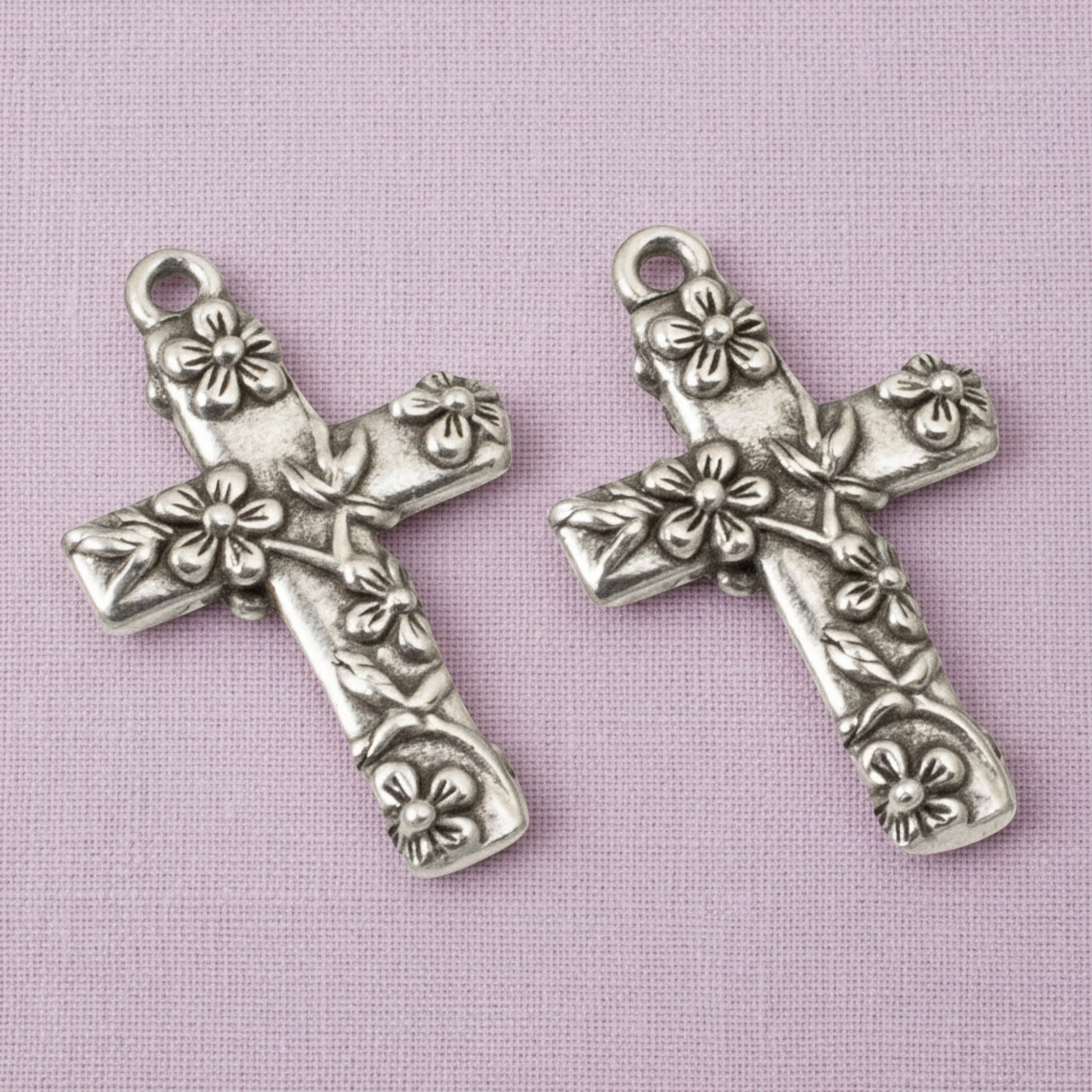 Hackberry Creek silver-plated pewter floral cross pendants with intricate raised flower details for religious jewelry.