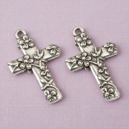 Hackberry Creek silver-plated pewter floral cross pendants with intricate raised flower details for religious jewelry.