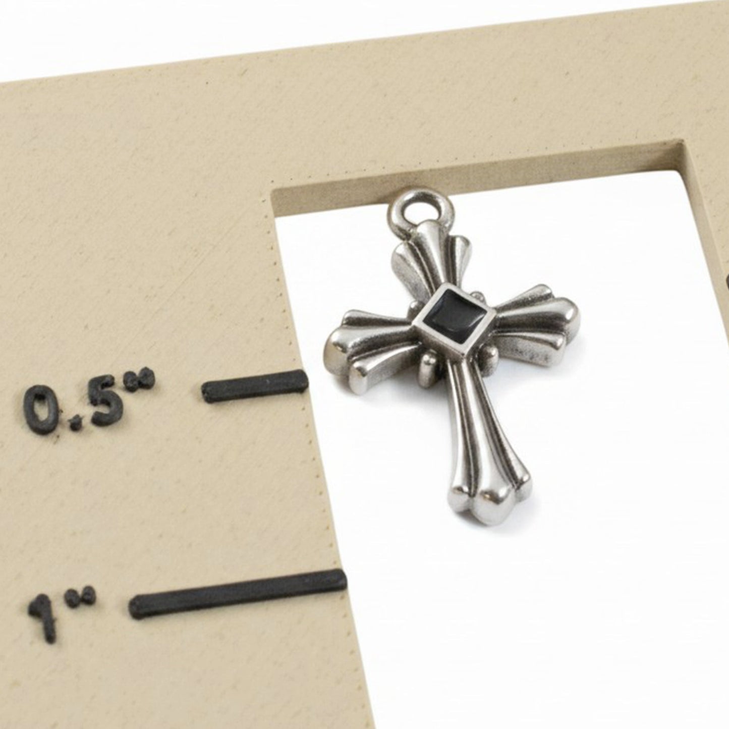 Hackberry Creek silver plated gothic cross pendant with black enamel center detail shown next to a size reference guide