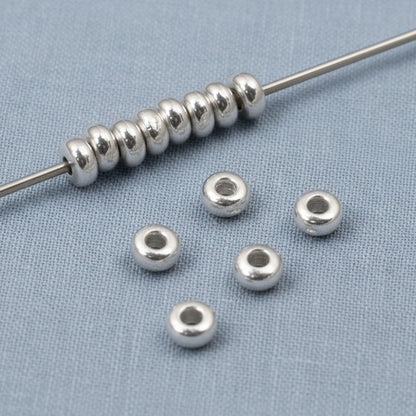 Hackberry Creek 3mm silver heishi disc spacer beads made of pewter with .999 fine silver plating. Smooth, bright finish.